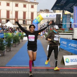 indian woman running through finish line