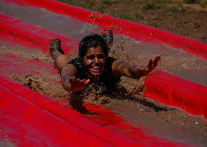 indian woman covered in mud down a slide